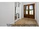 Bright entryway featuring hardwood floors, double glass doors, and a view of the home's exterior at 8021 Bud Morris Rd, Wake Forest, NC 27587