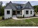 Charming home featuring a landscaped front yard, a covered porch, and a mix of modern and rustic elements at 8021 Bud Morris Rd, Wake Forest, NC 27587