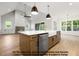 Open kitchen featuring a large island, stainless steel appliances, and hardwood floors, perfect for entertaining at 8021 Bud Morris Rd, Wake Forest, NC 27587