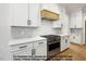 Modern kitchen featuring white countertops, a stainless steel range, and white cabinets at 8021 Bud Morris Rd, Wake Forest, NC 27587