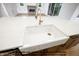 Close-up of kitchen island with a farmhouse sink, white countertop, and gold faucet at 8021 Bud Morris Rd, Wake Forest, NC 27587