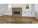 Open living space featuring custom built-ins and a modern fireplace with a wood mantel at 8021 Bud Morris Rd, Wake Forest, NC 27587