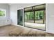 Bright living room with hardwood floors and a sliding glass door leading to a screened-in porch at 8021 Bud Morris Rd, Wake Forest, NC 27587