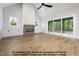 Open-concept living room with hardwood floors, a fireplace, and a large sliding door to an outdoor space at 8021 Bud Morris Rd, Wake Forest, NC 27587