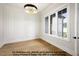 An office featuring decorative wall trim, hardwood floors, a modern chandelier, and a large window at 8021 Bud Morris Rd, Wake Forest, NC 27587
