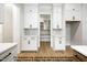 Open pantry featuring white cabinets and wooden shelving at 8021 Bud Morris Rd, Wake Forest, NC 27587