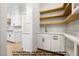 Walk-in pantry featuring white cabinets, gold faucet, and wooden shelving at 8021 Bud Morris Rd, Wake Forest, NC 27587
