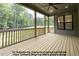 Inviting screened porch with wood flooring and views of the landscaped backyard at 8021 Bud Morris Rd, Wake Forest, NC 27587