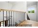 Staircase featuring a modern chandelier, wood handrail with black iron spindles, and natural light from a window at 8021 Bud Morris Rd, Wake Forest, NC 27587