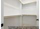 Walk-in closet featuring custom shelving with wooden rods, offering ample storage space at 8021 Bud Morris Rd, Wake Forest, NC 27587