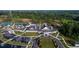 Stunning aerial view of community clubhouse featuring a pool, tennis courts, and ample parking at 805 Narrative Ln, Durham, NC 27703
