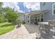 A cozy back patio with stone accents, shaded seating, and a beautiful green lawn at 805 Narrative Ln, Durham, NC 27703
