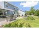 A spacious backyard features a stone patio, outdoor kitchen, and lush lawn at 805 Narrative Ln, Durham, NC 27703