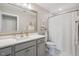 Bright bathroom with a vanity, a large mirror, and a shower-tub combination at 805 Narrative Ln, Durham, NC 27703