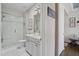 Elegant bathroom with white vanity, framed mirror, glass shower, and white tile floors at 805 Narrative Ln, Durham, NC 27703