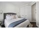 Comfortable bedroom featuring a soft bed, shiplap accent wall, and a closet at 805 Narrative Ln, Durham, NC 27703