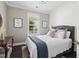 Cozy bedroom featuring shiplap accent wall, hardwood floors, and a comfortable bed at 805 Narrative Ln, Durham, NC 27703