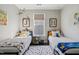 Bright bedroom featuring twin beds, a colorful rug, and cheerful decor, creating a fun and inviting space at 805 Narrative Ln, Durham, NC 27703