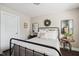 Neutral bedroom with a metal bed frame, soft linens, and decorative pillows at 805 Narrative Ln, Durham, NC 27703