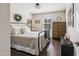 Comfortable bedroom with dark hardwood flooring, a metal bed frame, and natural lighting at 805 Narrative Ln, Durham, NC 27703
