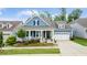 Charming home with a welcoming front porch, well-manicured landscaping, and a convenient two-car garage at 805 Narrative Ln, Durham, NC 27703