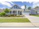 Stunning blue home with a charming front porch, manicured lawn, and a convenient two-car garage at 805 Narrative Ln, Durham, NC 27703