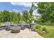 Outdoor seating area with a modern fire pit and lush greenery, great for entertaining at 805 Narrative Ln, Durham, NC 27703