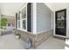 Inviting front entrance with a stylish door, decorative wreath, and charming porch details at 805 Narrative Ln, Durham, NC 27703