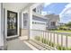 View of the porch with the front door and a view of the garage at 805 Narrative Ln, Durham, NC 27703