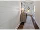 Inviting hallway with hardwood floors, shiplap accent wall, and stylish console table near a white front door at 805 Narrative Ln, Durham, NC 27703