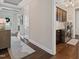 Inviting hallway leading to the laundry room and front entrance, showcasing hardwood floors and neutral decor at 805 Narrative Ln, Durham, NC 27703