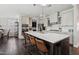 Bright kitchen with a large island, pendant lighting, and seamlessly connected to the dining and living areas at 805 Narrative Ln, Durham, NC 27703