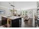 Open concept kitchen and living room featuring a large island, stone fireplace, and comfortable seating area at 805 Narrative Ln, Durham, NC 27703