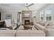 Cozy living room featuring a stone fireplace, ample seating, and natural light at 805 Narrative Ln, Durham, NC 27703