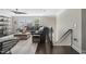 This living room features hardwood floors, a comfortable sofa, and a staircase at 805 Narrative Ln, Durham, NC 27703
