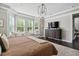 This main bedroom is equipped with a bay window that offers natural light and a dark wood dresser at 805 Narrative Ln, Durham, NC 27703