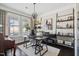 Well-appointed office with hardwood floors, plantation shutters, custom shelving, and a modern light fixture at 805 Narrative Ln, Durham, NC 27703