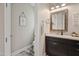 This powder room features a modern vanity with a granite countertop and decorative mirror at 805 Narrative Ln, Durham, NC 27703