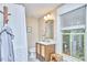 Bright bathroom with a modern vanity, stylish mirror, and a window for natural light at 813 Burch Ave, Durham, NC 27701