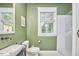 Green painted walls in a nicely renovated bathroom at 813 Burch Ave, Durham, NC 27701