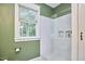 Well-lit bathroom features a walk-in shower, white subway tile, and a window for natural light at 813 Burch Ave, Durham, NC 27701