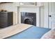 Charming bedroom with a decorative fireplace, dresser, and a cozy blue bed at 813 Burch Ave, Durham, NC 27701