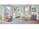 Cozy Bedroom with a white crib, rocking chair, and ample natural light from two windows at 813 Burch Ave, Durham, NC 27701