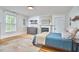 Spacious bedroom with hardwood floors, a fireplace, and a window for natural light at 813 Burch Ave, Durham, NC 27701