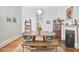Dining room features a modern table, chairs, fireplace and stylish lighting at 813 Burch Ave, Durham, NC 27701