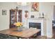 Charming dining room with a wood table, fireplace, and a decorative hutch at 813 Burch Ave, Durham, NC 27701