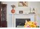 Close-up of the fireplace with white mantel, decorative items and a painting on the wall at 813 Burch Ave, Durham, NC 27701