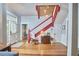 Open foyer with red-painted staircase, hardwood floors, rocking chair and stylish lighting at 813 Burch Ave, Durham, NC 27701