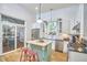 Bright, airy kitchen with island, stainless appliances, and view to the outdoor dining area at 813 Burch Ave, Durham, NC 27701