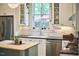 Bright kitchen featuring white cabinetry, stainless steel appliances, and an island with breakfast bar at 813 Burch Ave, Durham, NC 27701